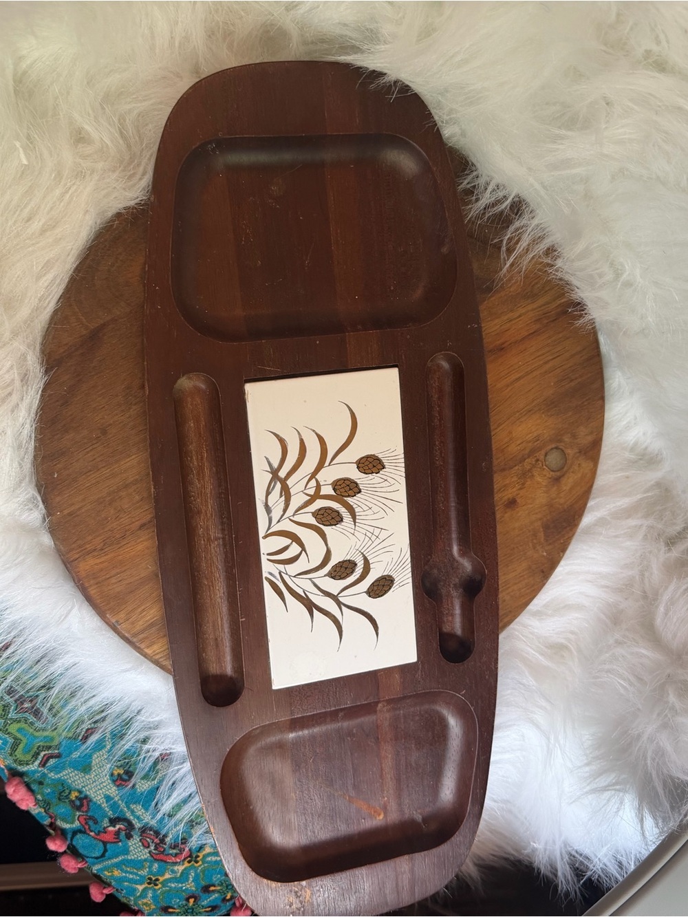 Mid-century wooden cheese board with a decorative ceramic tile insert.